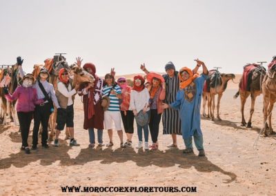 Morocco Explore Tours clients with camels in Merzouga